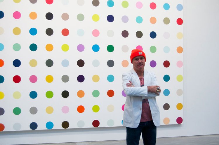 Damian Hirst standing in front of one of his famous spot paintings (c) Andrew Russeth