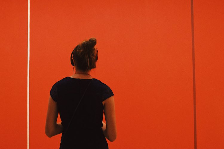 Person standing in front of a Barnett Newman painting